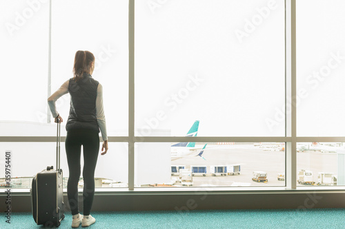 Tablou pe pânză COVID-19 Pandemic border closures, young woman waiting for the plane returning h