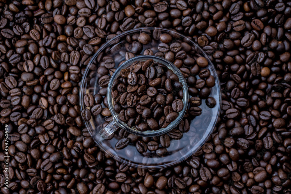 Fototapeta premium coffee beans in a cup and around the cup