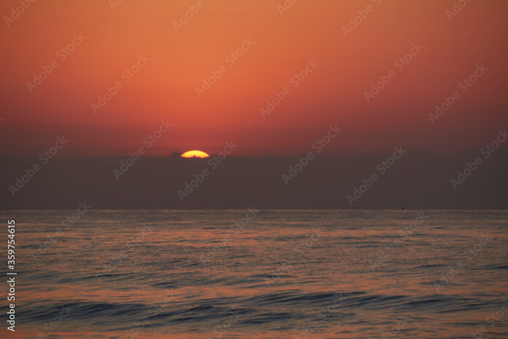 Sunrise in the ocean, the sun appears