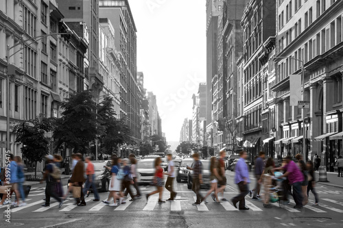 Photography Colorful people walking across a busy intersection in a black and white Manhatta