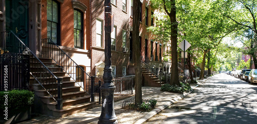 Tableau sur toile Sunlight shines on a block of historic brownstone buildings in the East Village