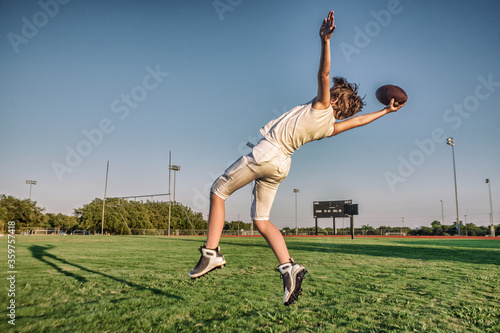 Youth Sports Boy Playing Football on Football Field