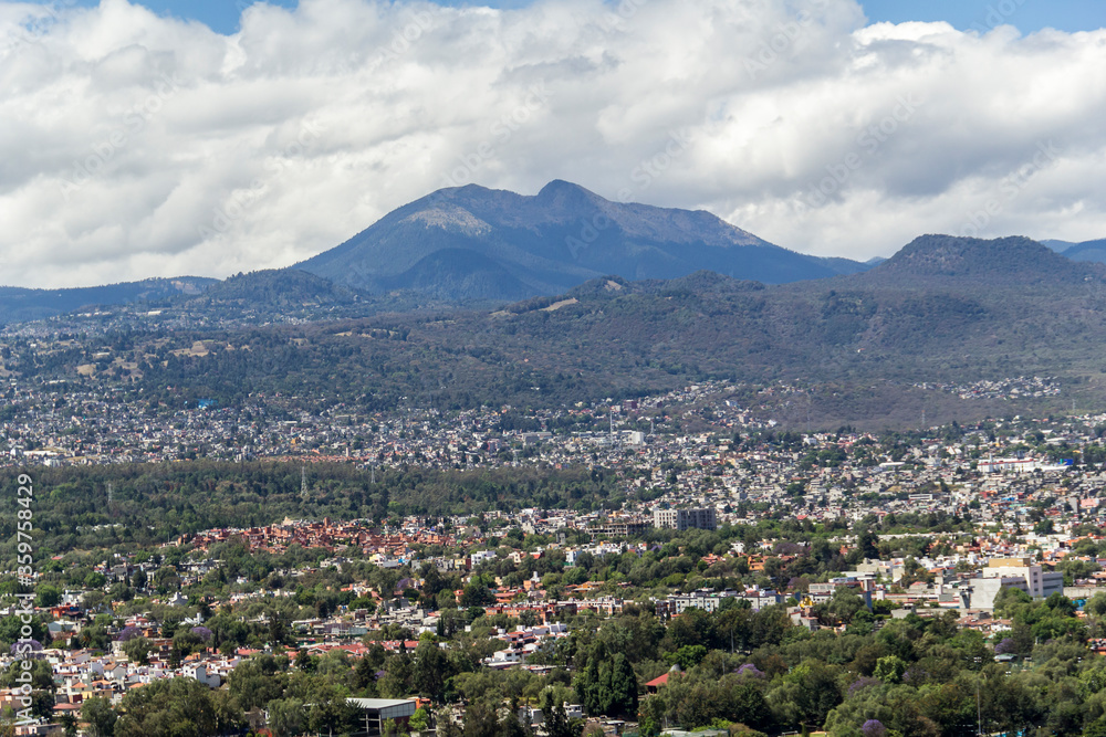 Aerial view of the most southern part of Mexico City, above Tlalpan district and with the mountains Ajusco and Xitle in the back