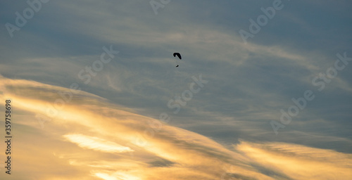 Paraglider on bright and vivid dawn sky in the arctic circle
