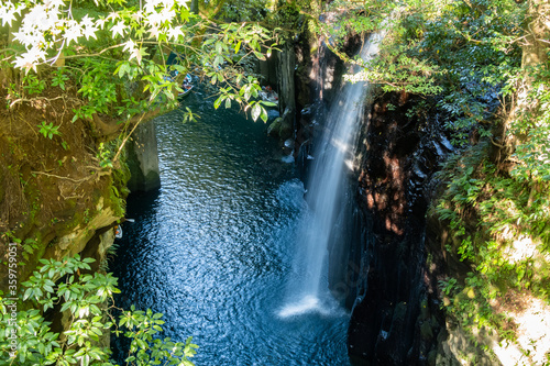 View from above at Takachiho Gorge cliffs and waterfall by the Gokase River, tourist attraction on Kyushu Island, Japan photo