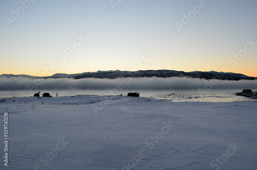 ice fog over fjord at sunset