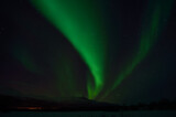 strong aurora borealis, northern light over frozen arctic circle landscape in winter night
