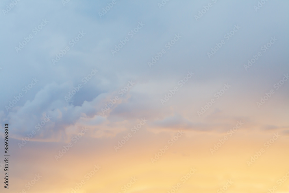 Cloudy weather background, pastel cloudscape, clouds sky and glow of setting sun in peaceful evening light subtle layers