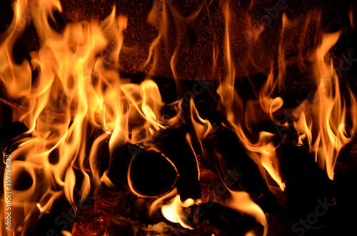 Hot vivid burning birch logs in fireplace
