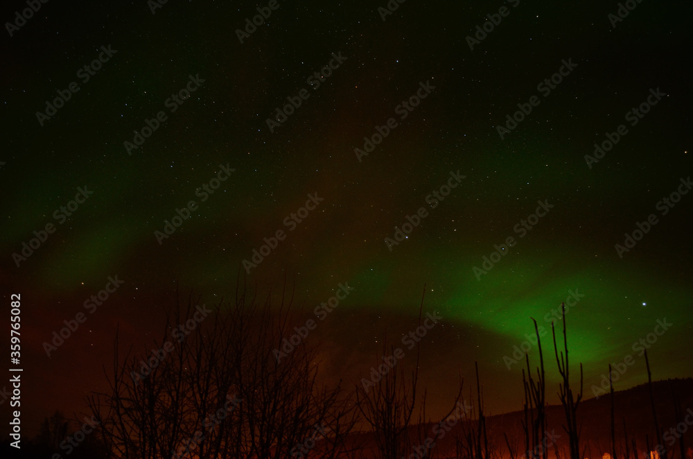 aurora borealis, northern light on a fire red sky in the arctic circle in the night, winter time