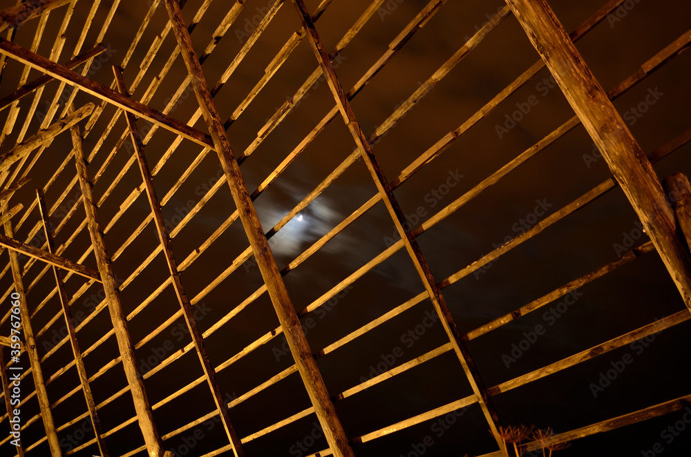 old wooden stockfish structure at night old wooden stockfish structure at night