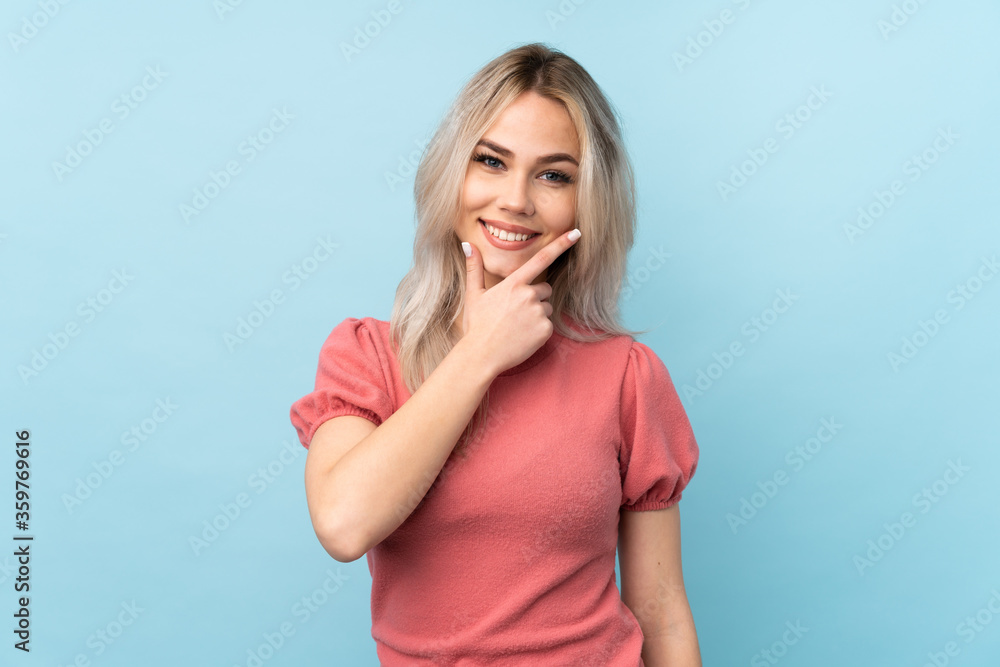 Teenager girl over isolated blue background smiling Teenager girl over isolated blue background smiling