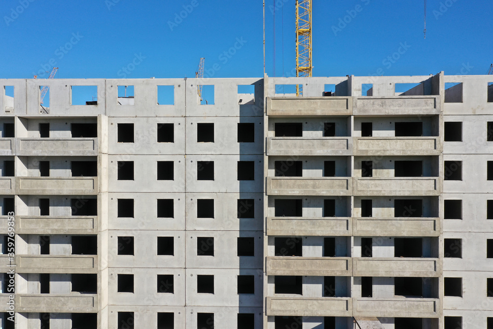 Fototapeta premium A fragment of a grey panel house under construction. Copy space.
