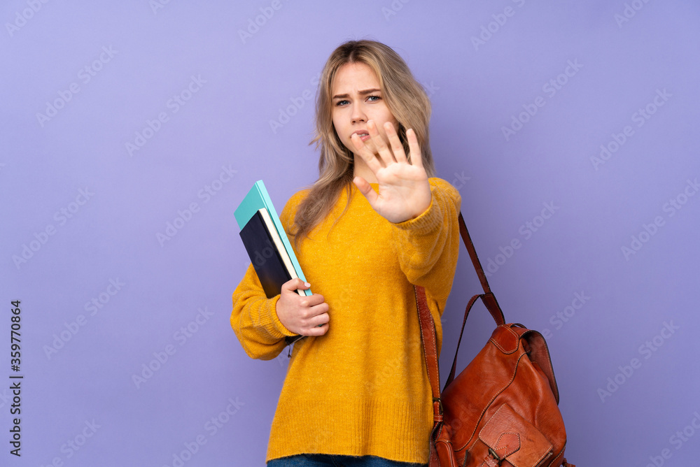 Teenager Russian student girl isolated on purple background nervous stretching hands to the front Teenager Russian student girl isolated on purple background nervous stretching hands to the front