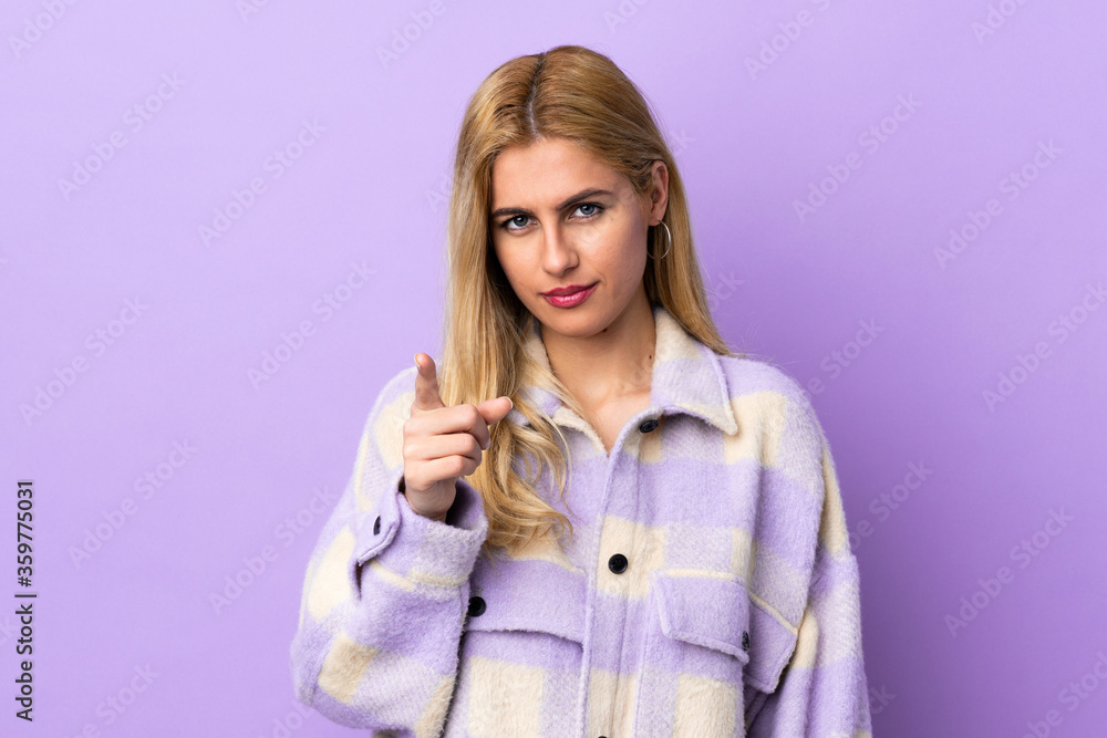 Young Uruguayan blonde woman over isolated background frustrated and pointing to the front Young Uruguayan blonde woman over isolated background frustrated and pointing to the front