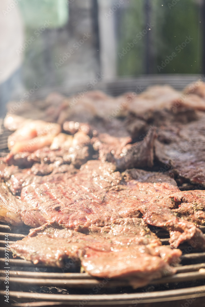 setting charcoal to make a family barbecue of meat on a grill setting charcoal to make a family barbecue of meat on a grill