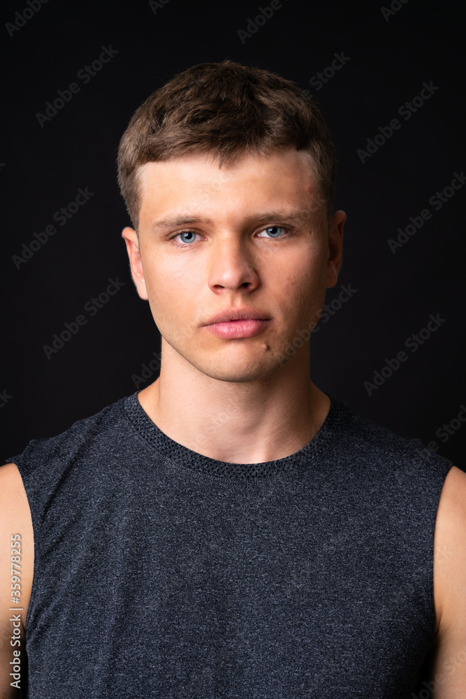 Portrait of young man over isolated black background Portrait of young man over isolated black background