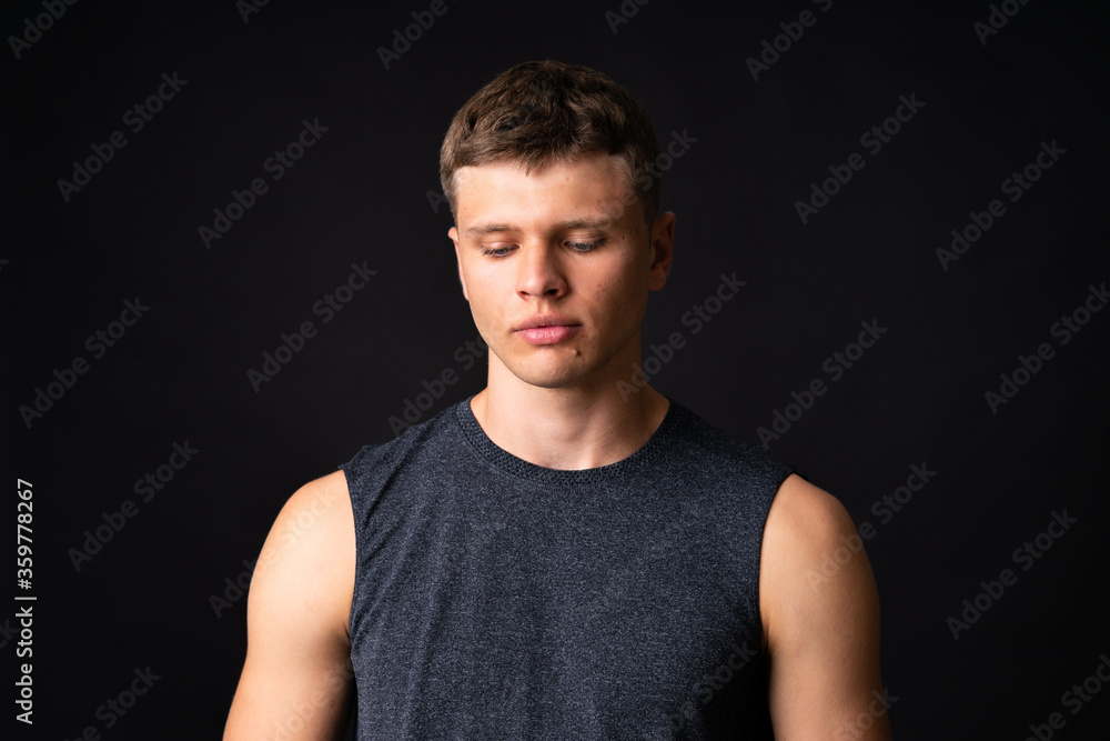 Obraz premium Portrait of young man over isolated black background