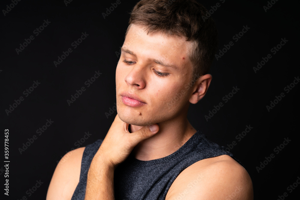 Obraz premium Portrait of young man over isolated black background