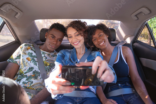 App car passengers taking selfie.