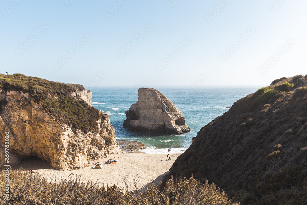 People enjoying the secluded beach of California's Shark Fin Cove 