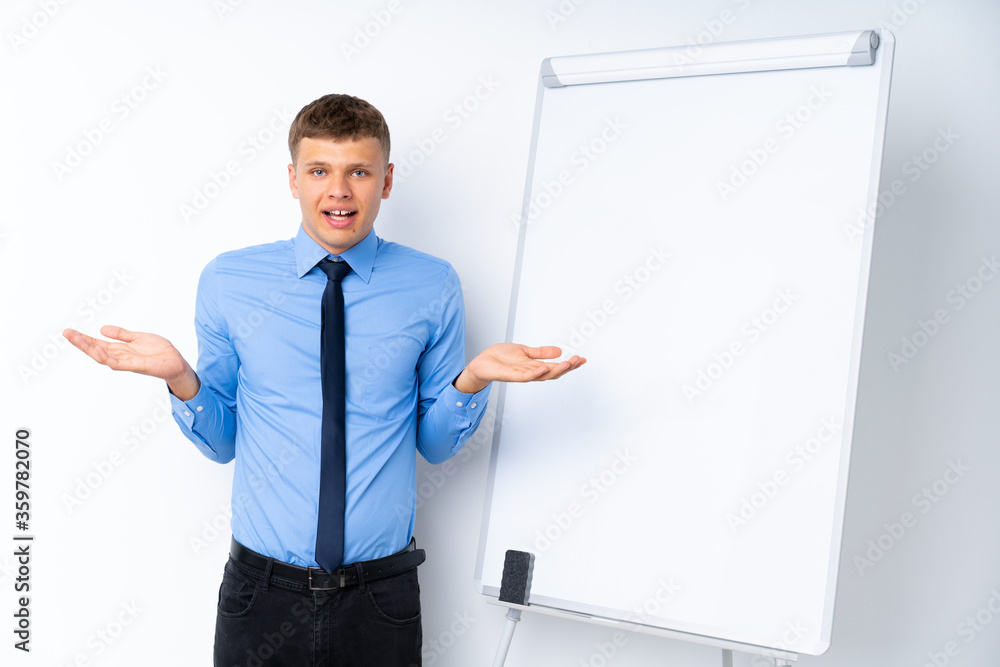 Young businessman giving a presentation on white board with shocked facial expression Young businessman giving a presentation on white board with shocked facial expression