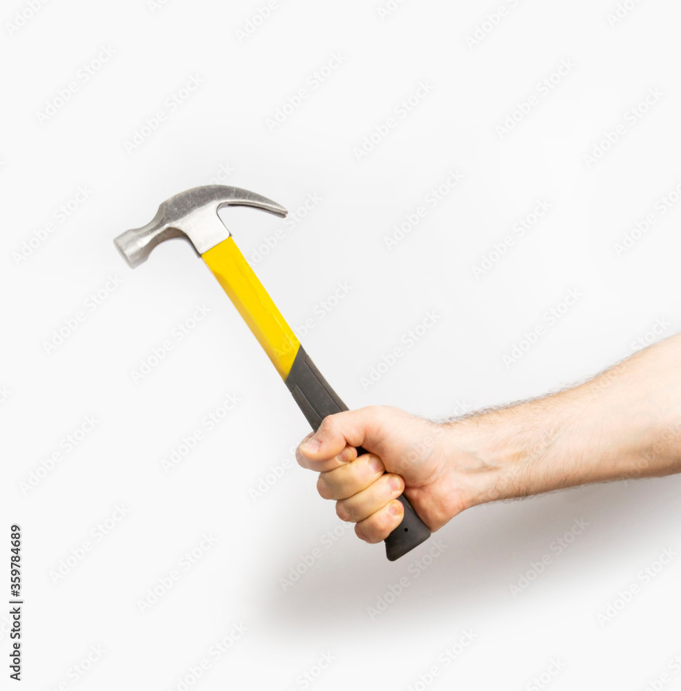 hammer in male hands on a white background. close-up. hammer in male hands on a white background. close-up.