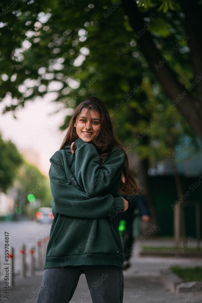 Portrait of cute girl with long hair looks at the camera