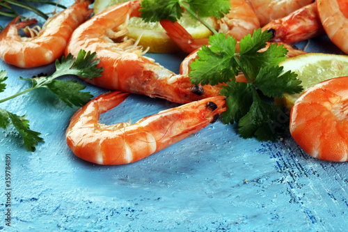 Raw fresh Prawns Langostino Austral. shrimp seafood with fresh lemon and spices.
