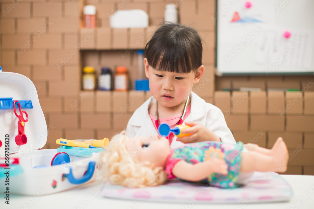 Fototapeta premium toddler girl pretend play doctor role at home