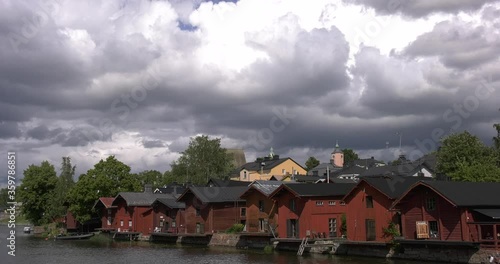 4K video of Porvoo vintage red wooden buildings, Porvoo Cathedral, yachts and boats in Porvoonjoki River near town center on sunny summer day in Finland, northern Europe photo