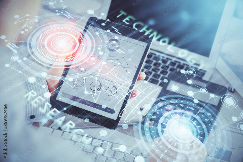 Double exposure of man's hand holding and using a digital device and data theme hologram drawing. Technology concept. Double exposure of man's hand holding and using a digital device and data theme hologram drawing. Technology concept.
