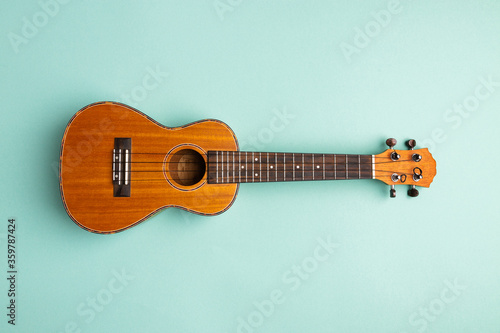 Ukulele isolated on abstract blue background with copy space photo