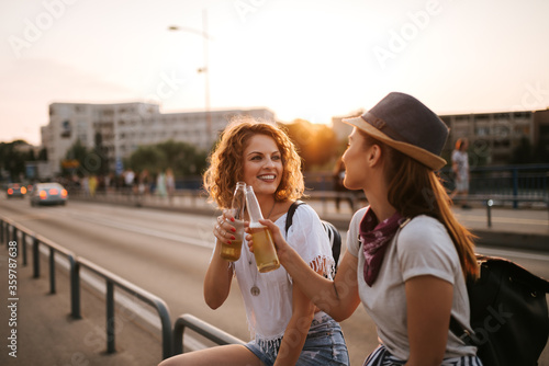 Two beautiful hipster woman celebrating on a summer holiday.
