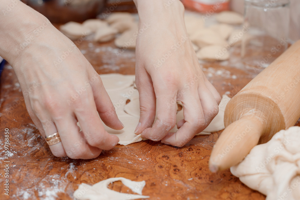 Kneading the dough. Rolling pin and rolling out the dough. Flour dough. Cooking in the kitchen.