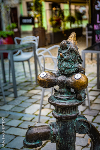 Copper dwarf sitting on a hydrant from Wroclaw.