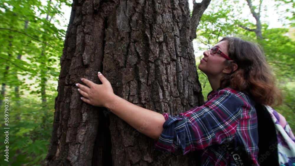 Young woman is hugging a tree with love and respect to nature. Russia Young woman is hugging a tree with love and respect to nature. Russia