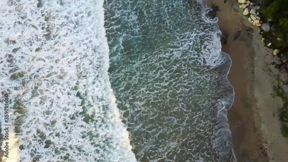 Zenithal aerial drone shooting of the waves and sea foam of Treasur Beach, Jamaica. Point of view rising and moving away from the scene. Zenithal aerial drone shooting of the waves and sea foam of Treasur Beach, Jamaica. Point of view rising and moving away from the scene.