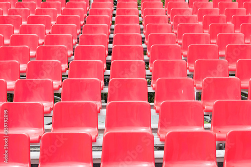 Rows of empty red grandstand seats, selective focus