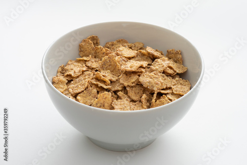 Bowl of whole grain muesli isolated on the white background.