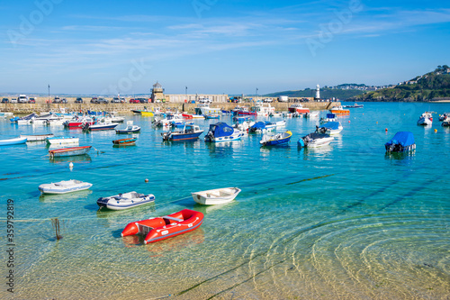 Fishing boats moored in harbour at beautiful British seaside town St Ives, Cornwall, England photo