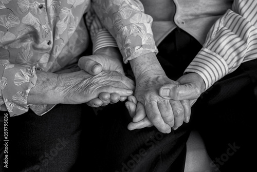 Older people holding hands close-up. Wrinkled hands of elderly people.