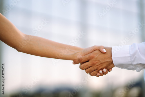 Handshake of business partners after a favorable deal relationships to achieve future commercial and investment goals.