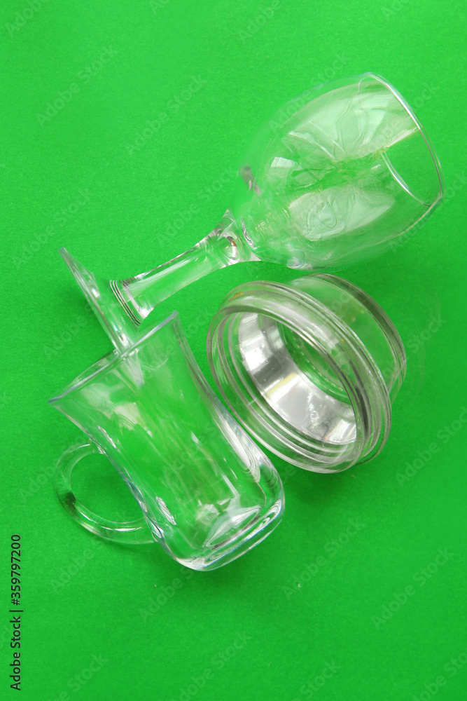 Glass debris on a green monochrome background. Concept of waste recycling. Glass debris on a green monochrome background. Concept of waste recycling.
