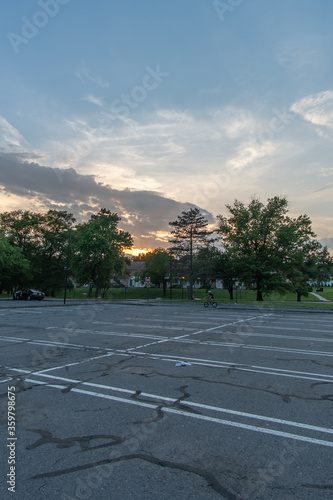 East Brunswick, New Jersey - May 25, 2019: the parking lot of the local public library (EBPL) is empty except for a kid practicing some tricks on his bike.
