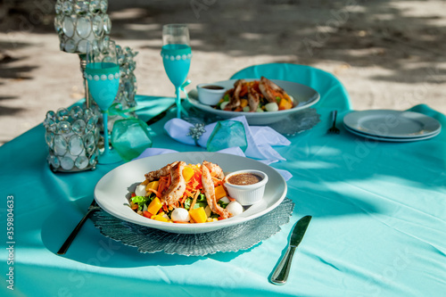 Caribbean lunch on the beach for luxury private excursions served on the dishes and table for 2 person 