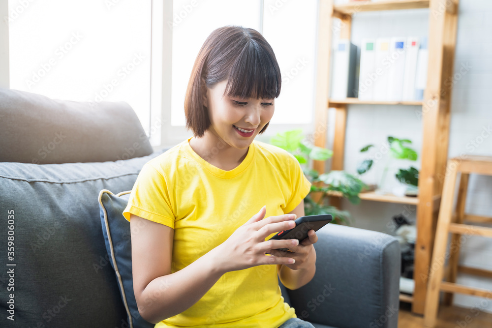 Using mobile phone smart device surfing internet watching playing on technology at home in living room relaxing enjoying lifestyle lockdown quarantine self isolation Asian woman casual care free Using mobile phone smart device surfing internet watching playing on technology at home in living room relaxing enjoying lifestyle lockdown quarantine self isolation Asian woman casual care free