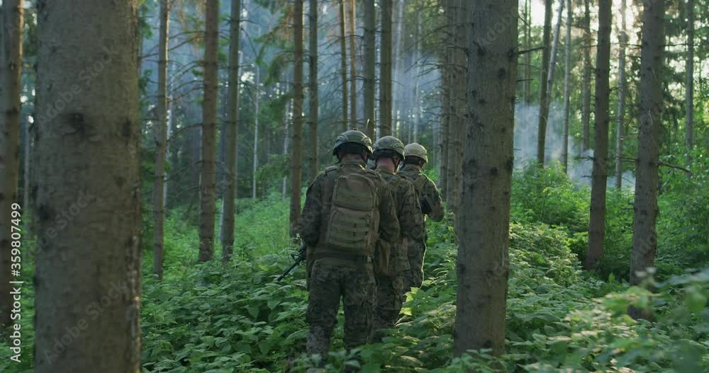 Fully Equipped Soldiers Wearing Camouflage Uniform Attacking Enemy during day time Fully Equipped Soldiers Wearing Camouflage Uniform Attacking Enemy during day time