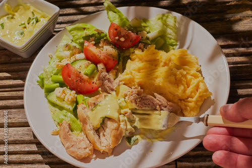 Summer chicken with salad and creamed potatoes,with some hard shadows from sunlight. photo