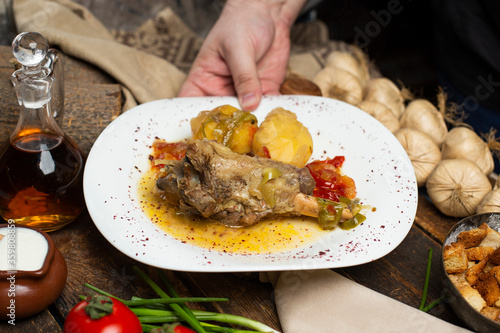 delicious meat and potato meal with wooden background